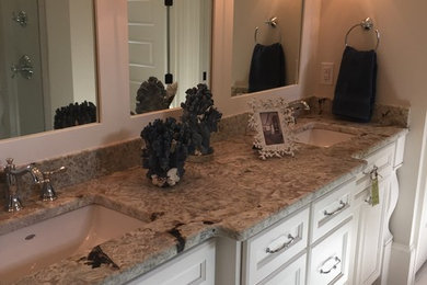 Example of a mid-sized transitional master porcelain tile and gray floor bathroom design in Other with recessed-panel cabinets, white cabinets, gray walls, an undermount sink, granite countertops and gray countertops