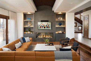 This is an example of a large contemporary open concept living room in Denver with grey walls, a ribbon fireplace, a wall-mounted tv, brown floor, medium hardwood floors, a concrete fireplace surround and wood.