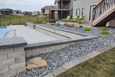 Backyard concrete paver patio photo in Omaha