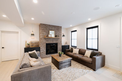Mid-sized mountain style open concept vinyl floor and beige floor living room photo in Vancouver with white walls, a standard fireplace and a brick fireplace