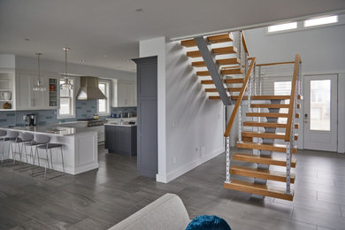 Entryway - large modern ceramic tile and gray floor entryway idea in Other with gray walls and a gray front door