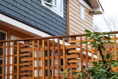 Example of a mid-sized transitional blue two-story mixed siding exterior home design in Boston with a shingle roof