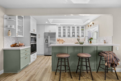 Eat-in kitchen - traditional vinyl floor, brown floor and coffered ceiling eat-in kitchen idea in Orange County with a farmhouse sink, shaker cabinets, quartzite countertops, marble backsplash and stainless steel appliances