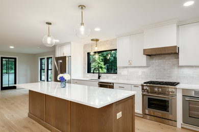 Example of a large transitional galley light wood floor and beige floor eat-in kitchen design in Boston with a single-bowl sink, shaker cabinets, white cabinets, quartz countertops, white backsplash, ceramic backsplash, stainless steel appliances, an island and white countertops