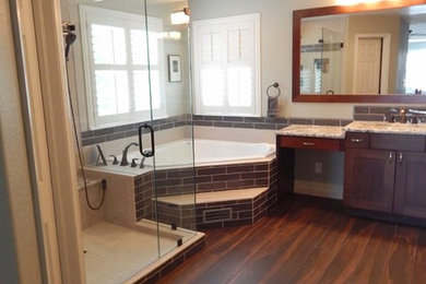 Design ideas for a large transitional master bathroom in Denver with shaker cabinets, dark wood cabinets, a corner tub, an alcove shower, a two-piece toilet, brown tile, ceramic tile, beige walls, porcelain floors, an undermount sink and granite benchtops.