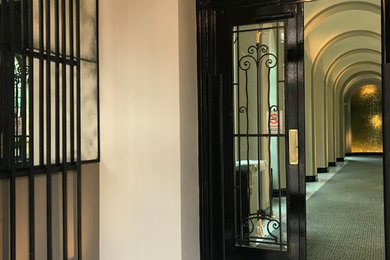 Classic vestibule in London with marble flooring, a double front door and a black front door.