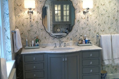 Corner shower - mid-sized transitional master white tile and stone tile marble floor corner shower idea in Philadelphia with an undermount sink, beaded inset cabinets, gray cabinets, marble countertops, a two-piece toilet and multicolored walls