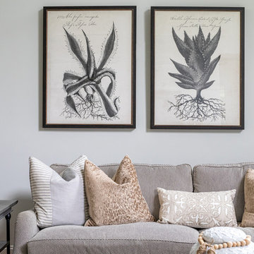Neutral Two Story Family Room with Tufted Wing Chairs
