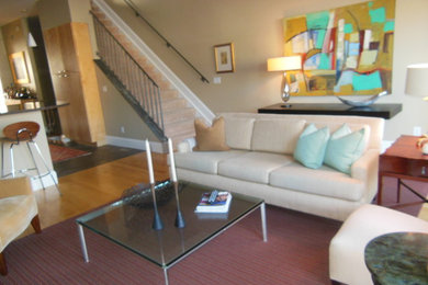Example of a large trendy open concept light wood floor family room design in Cincinnati with beige walls, no fireplace and no tv