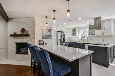 Inspiration for a large modern u-shaped ceramic tile, beige floor and coffered ceiling eat-in kitchen remodel in Houston with a drop-in sink, raised-panel cabinets, brown cabinets, quartzite countertops, white backsplash, ceramic backsplash, stainless steel appliances, an island and white countertops