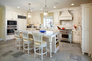 Elegant ceramic tile eat-in kitchen photo in Milwaukee with paneled appliances, white cabinets, marble countertops, an island and marble backsplash