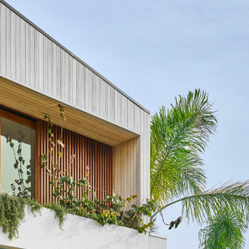 Timber Batten Facade with Lush Balcony Planting