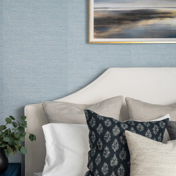Coastal Inspired Guest Bedroom With Blue Grasscloth Wallpaper And Bedside Sconce