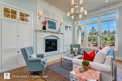Inspiration for a large coastal open concept medium tone wood floor family room remodel in Boise with blue walls, a standard fireplace, a tile fireplace and a concealed tv