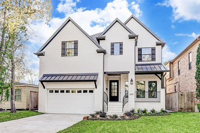 Example of a cottage white two-story brick house exterior design in Houston