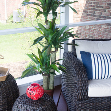 Wicker Woven Chair and Round Side Table with Bold Red Lantern