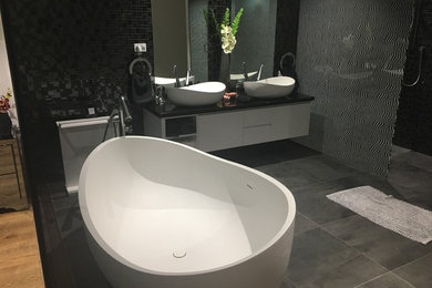 Large contemporary master bathroom in Sydney with open cabinets, white cabinets, a freestanding tub, a double shower, a wall-mount toilet, black tile, mosaic tile, marble floors, a vessel sink, quartzite benchtops, grey floor and an open shower.