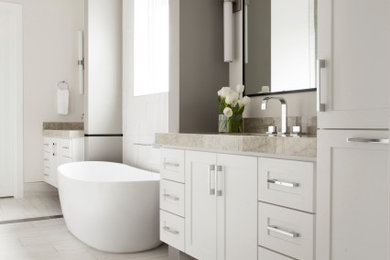 Transitional white floor and double-sink freestanding bathtub photo in Dallas with shaker cabinets, white cabinets, gray walls, gray countertops and a built-in vanity