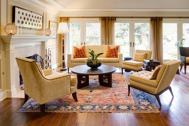 Mid-sized elegant formal and open concept medium tone wood floor and brown floor living room photo in San Francisco with beige walls, a standard fireplace, a tile fireplace and no tv