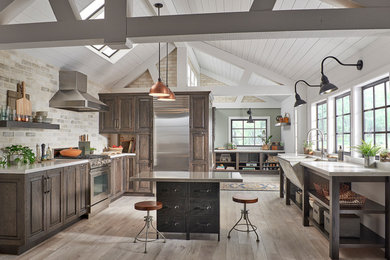 Large transitional u-shaped open plan kitchen in Other with a farmhouse sink, raised-panel cabinets, dark wood cabinets, multi-coloured splashback, stainless steel appliances, with island and beige floor.