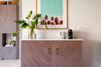 This is an example of a small eclectic home studio in Los Angeles with grey walls, porcelain floors and a freestanding desk.