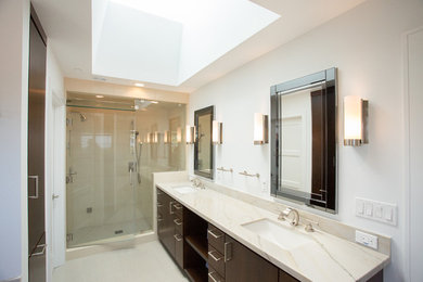 Large trendy master ceramic tile alcove shower photo in San Francisco with flat-panel cabinets, dark wood cabinets, white walls, an undermount sink and granite countertops