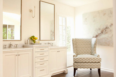 Example of a large master beige tile medium tone wood floor bathroom design in San Diego with shaker cabinets, beige cabinets, beige walls, an integrated sink and quartzite countertops