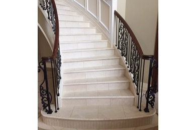 Inspiration for a mid-sized transitional tile curved metal railing staircase remodel in Other with tile risers