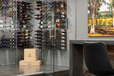 Example of a minimalist porcelain tile wine cellar design in Minneapolis