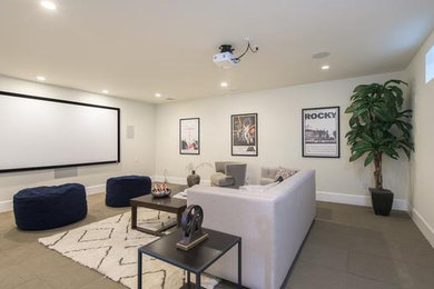 Home theater - large transitional enclosed concrete floor and gray floor home theater idea in Los Angeles with beige walls and a projector screen