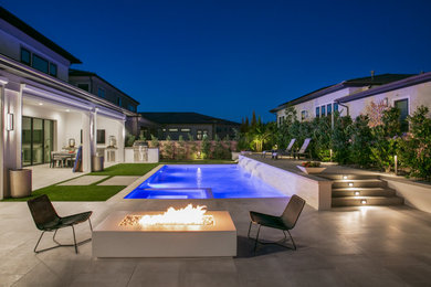 Example of a large transitional backyard tile and rectangular pool landscaping design in San Diego