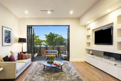 Photo of a contemporary living room in Melbourne with a wall-mounted tv.