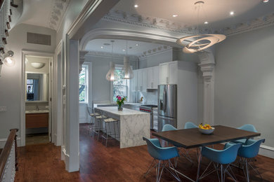 Example of a huge transitional l-shaped dark wood floor open concept kitchen design in New York with an undermount sink, shaker cabinets, marble countertops, white backsplash, marble backsplash, stainless steel appliances and an island