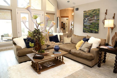 Inspiration for a mid-sized transitional open concept dark wood floor and beige floor family room remodel with beige walls, a standard fireplace, a metal fireplace and a wall-mounted tv