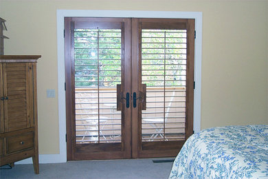 Example of a mid-sized guest carpeted and gray floor bedroom design in Boise with beige walls