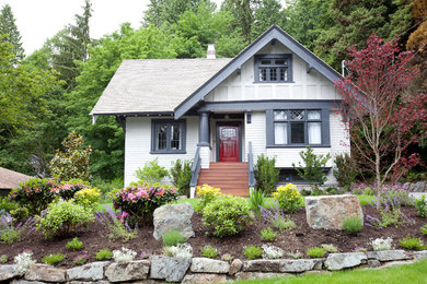Design ideas for a traditional two-storey grey exterior in Vancouver with wood siding.