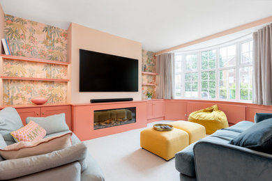 Medium sized eclectic formal enclosed living room in Hertfordshire with pink walls, carpet, a standard fireplace, a built-in media unit, beige floors, panelled walls and a chimney breast.