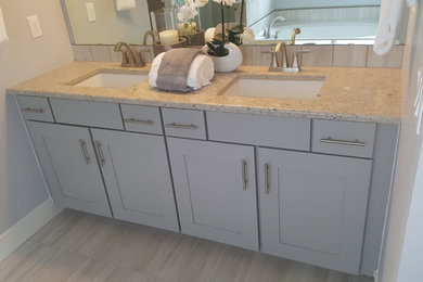 Example of a mid-sized cottage chic master gray tile and ceramic tile ceramic tile bathroom design in Denver with recessed-panel cabinets, gray cabinets, gray walls, an undermount sink and granite countertops