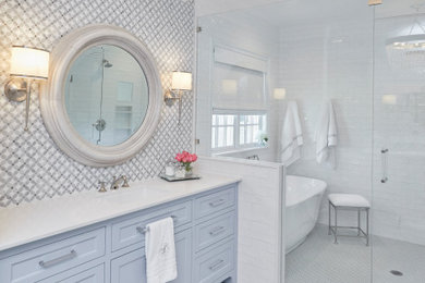 Bathroom - transitional master white tile and subway tile gray floor and single-sink bathroom idea in Dallas with shaker cabinets, blue cabinets, an undermount sink, a hinged shower door, white countertops and a built-in vanity