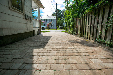 Inspiration for a traditional front yard stone driveway in Other.