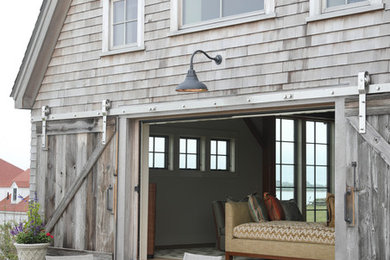 Example of a large cottage gray three-story wood house exterior design in Providence with a gambrel roof and a shingle roof