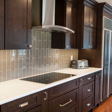 Contemporary Kitchen with Dark Cabinets and Glass Vertical Tile Backsplash