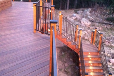 Example of a large arts and crafts backyard patio design in Denver with decking and no cover