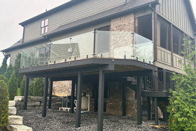 Inspiration for a mid-sized modern backyard second story glass railing deck remodel in Indianapolis