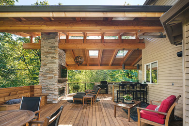 Design ideas for a mid-sized arts and crafts backyard deck in Portland with an outdoor kitchen and a roof extension.