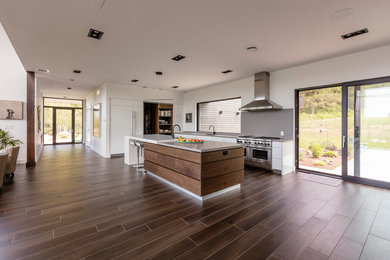 Trendy open concept kitchen photo in Toronto with flat-panel cabinets, white cabinets, quartz countertops, stainless steel appliances and an island