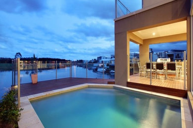 Photo of an expansive beach style pool in Brisbane.