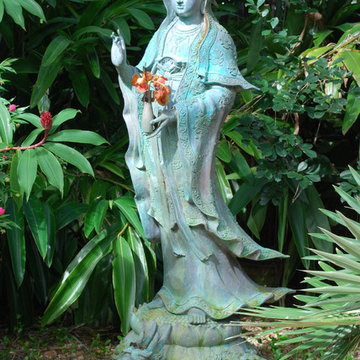 Asian sculpture brings tranquility to garden.