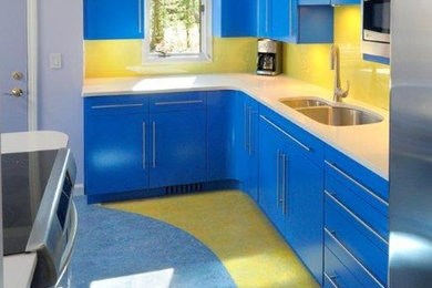 Inspiration for a contemporary kitchen remodel in New York with flat-panel cabinets, blue cabinets, quartz countertops, yellow backsplash and glass sheet backsplash