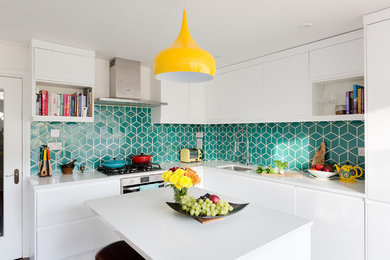 Design ideas for a mid-sized contemporary l-shaped eat-in kitchen in London with white cabinets, green splashback, ceramic splashback, stainless steel appliances, with island, an undermount sink and flat-panel cabinets.